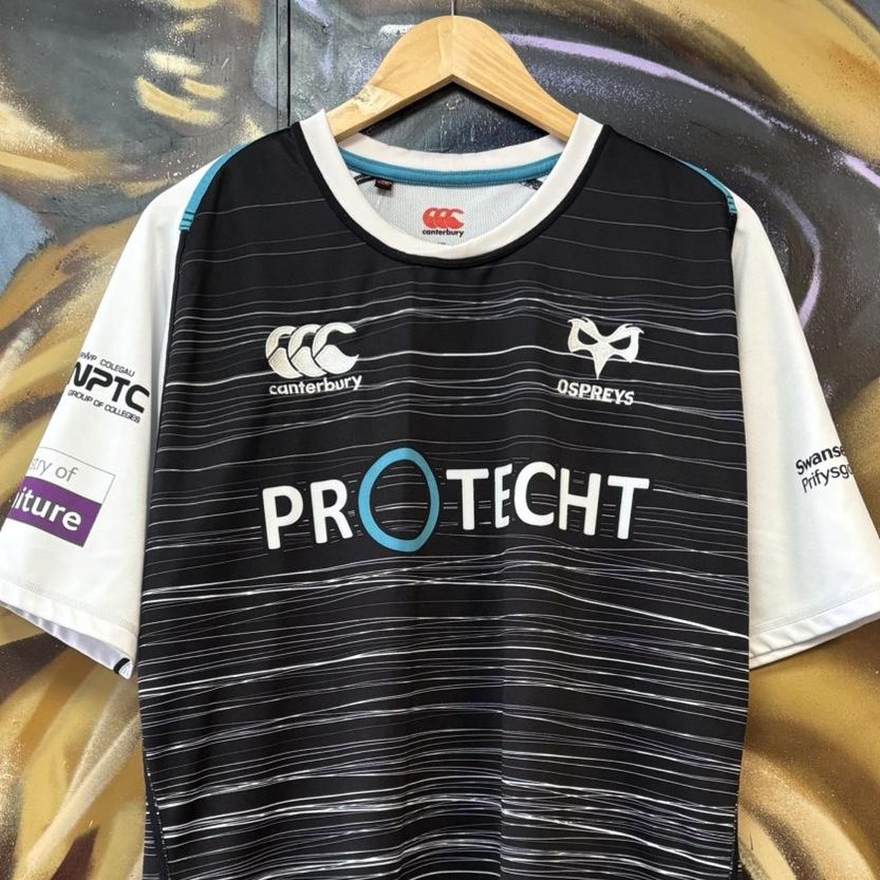 Vintage Retro Essential Canterbury Ospreys 2019 - 2020 Home Black Collared Rugby Short Sleeve Jersey with embroidered logo  and Swansea University, Protecht, Ministry of Furniture, NPTC, Philtronics Limited, morganstone and Keytree printed sponsorships