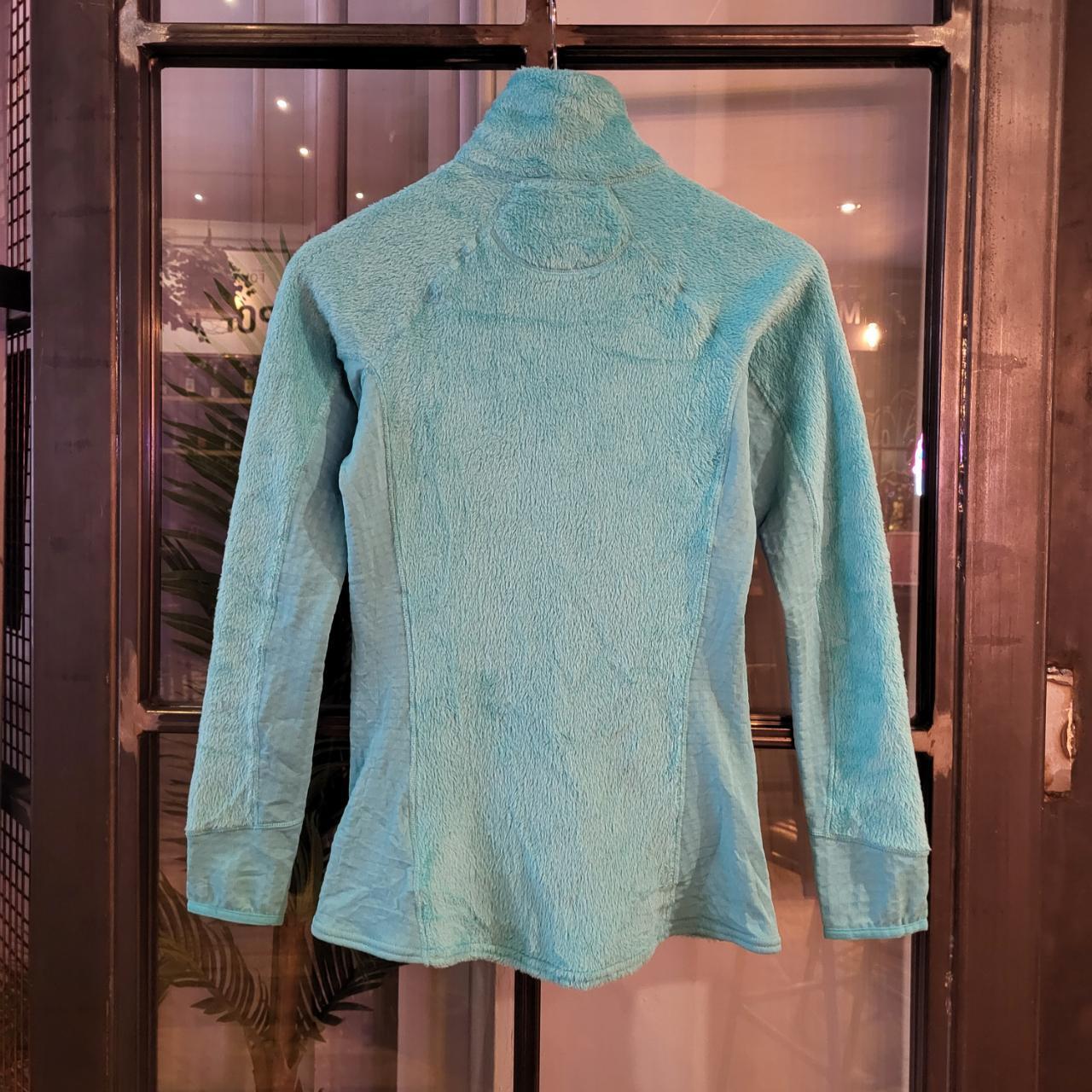 Vintage essential retro Aztec funky geometric tribal block pattern light blue turquiose Patagonia snap T popper quarter zip synchilla fleece sweatshirt pullover with small spellout logo as seen