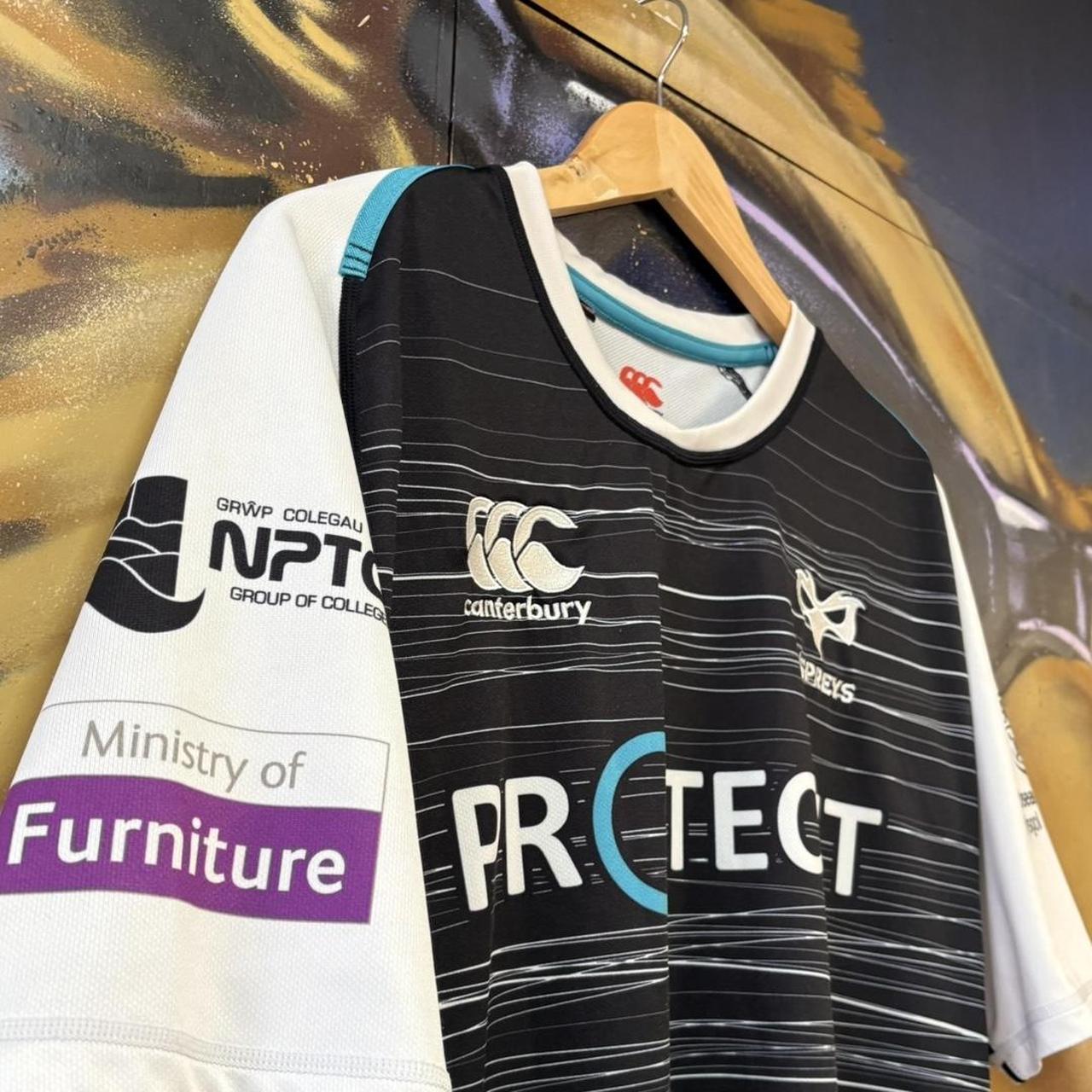 Vintage Retro Essential Canterbury Ospreys 2019 - 2020 Home Black Collared Rugby Short Sleeve Jersey with embroidered logo  and Swansea University, Protecht, Ministry of Furniture, NPTC, Philtronics Limited, morganstone and Keytree printed sponsorships