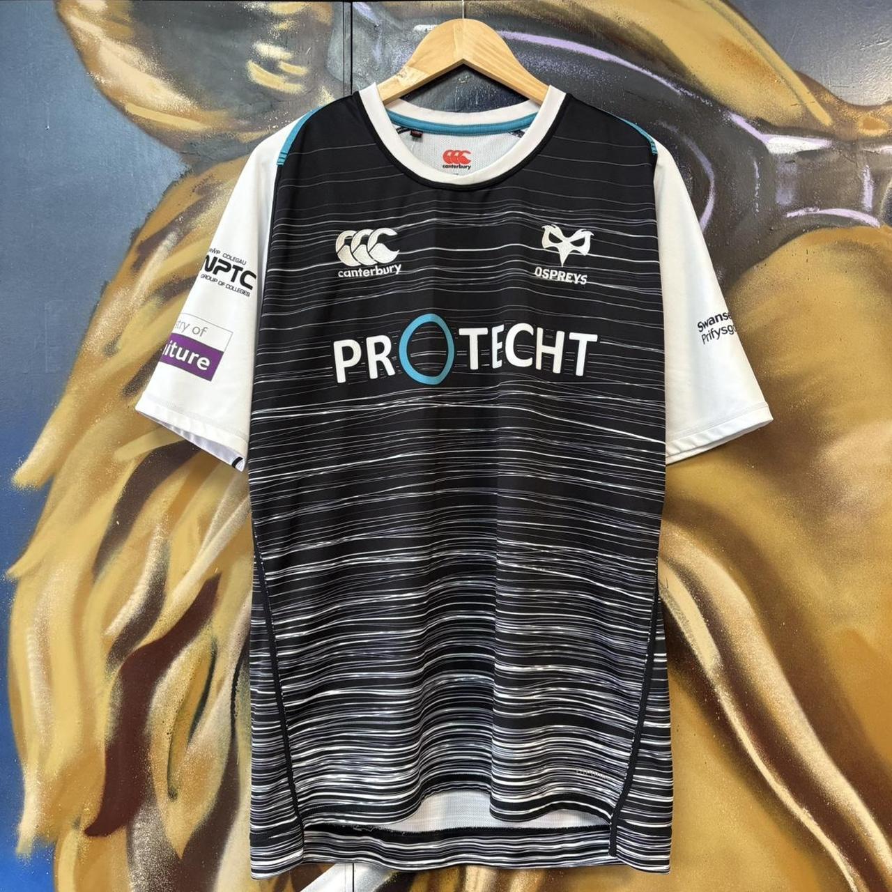 Vintage Retro Essential Canterbury Ospreys 2019 - 2020 Home Black Collared Rugby Short Sleeve Jersey with embroidered logo  and Swansea University, Protecht, Ministry of Furniture, NPTC, Philtronics Limited, morganstone and Keytree printed sponsorships