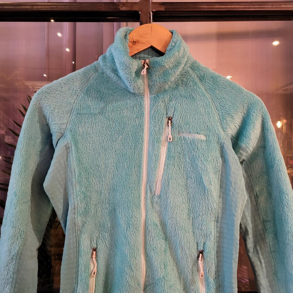 Vintage essential retro Aztec funky geometric tribal block pattern light blue turquiose Patagonia snap T popper quarter zip synchilla fleece sweatshirt pullover with small spellout logo as seen